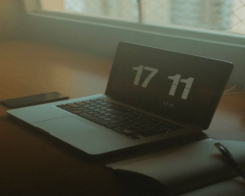 A laptop seamlessly aligned next to a side window allowing indirect natural morning daylight over a clean layout