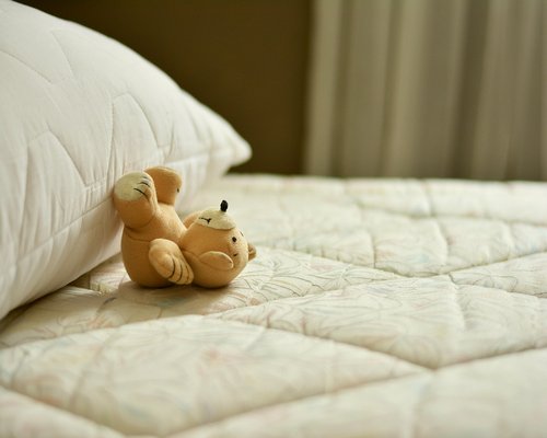 Indirect warm wall light setup softening a bedroom environment for pre-sleep relaxation hours